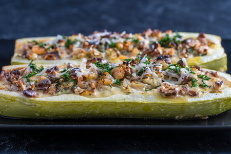 Zucchini stuffed with shrimps, vegetables and cheese. Baked zucchini boats, close upの写真素材
