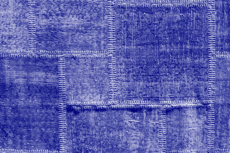 Detail of old asian patchwork carpet background and texture. close up. Trendy color of the year 2022. Ultra Violet creative and moody color of the pictureの写真素材
