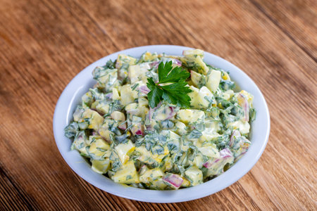 Salad of radish, boiled egg, parsley and sour cream in white bowl - healthy breakfast concept, close upの写真素材