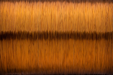 Metal texture of a coil of copper wire, close-up. Coil of thin copper wire on the backgroundの写真素材