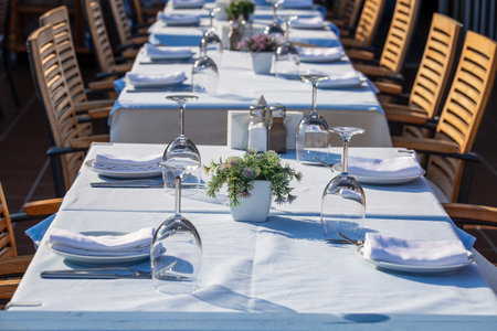 Elegant table setting with fork, knife, wine glass and napkin in restaurant. Nice dining table set with arranged silverware and napkins for dinner, Turkey, close upの写真素材