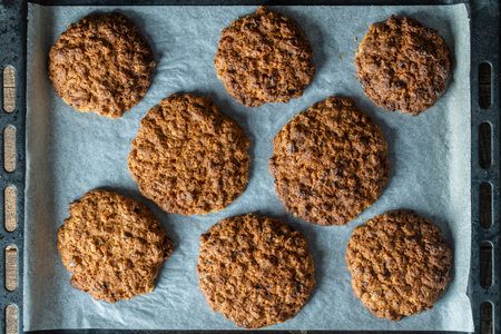 Delicious oatmeal cookies with walnuts on baking sheet, close up, top viewの写真素材
