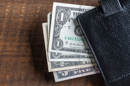 Cash American dollars banknotes in a leather wallet. paper money close up. The concept of payment...