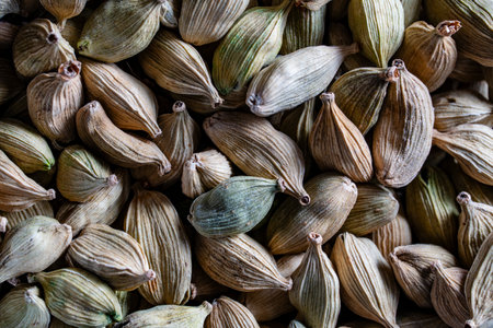 Dry organic green cardamom spice, macro, top view, background or texture. Healthy spices, nuts,...