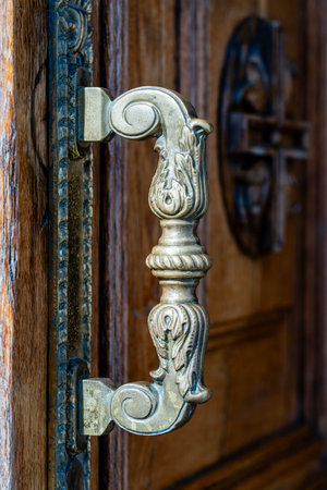Ancient door handle on a wooden door in church, Kyiv, Ukraine. Close upの写真素材