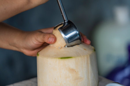 Woman opens a coconut in cafe on island Koh Phangan, Thailand, close upの写真素材