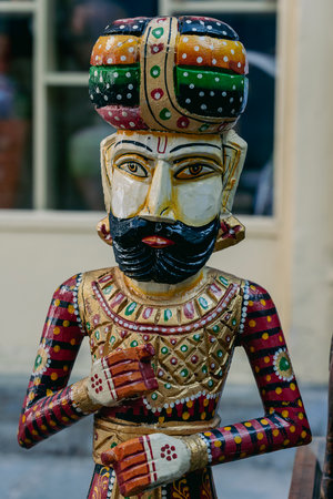 Detail of a wooden statue of a man on a city street Udaipur, Rajasthan, India. Close upの写真素材