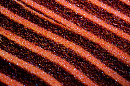 Small bright orange crystals of potassium dichromate, close up, abstract colorful background