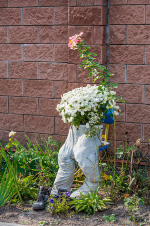 Jeans and boots as flowerpots in the autumn garden, close up. Garden decoration ideaの写真素材