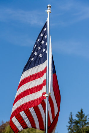 American flag over blue sky background, close upの写真素材