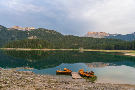 View of the Black Lake or Crno jezero , northern Montenegro. Tourist boats near wooden pier on Black lake in Durmitor national park near Zabljak, Europeの写真素材