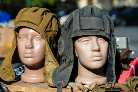 Two military tank old helmets on mannequins for sale to tourists at a street market in the center of Kyiv, Ukraine, close upの写真素材