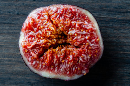 Fresh slice fig colorful background, top view, macro tropical fruits texture. Ripe figs rotate,...