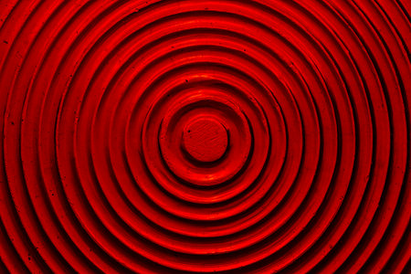 Bright red background and texture of the rear brake light of an old car, close up. Plastic red stop lightの写真素材