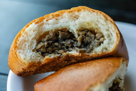 Pie with mushroom filling on white plate. Close upの写真素材