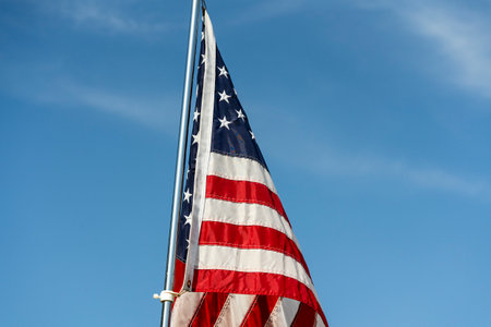 American flag over blue sky background, close up