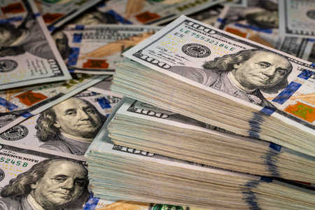 Background of many American one hundred dollar banknotes. A pile of new one hundred US dollars. Cash...