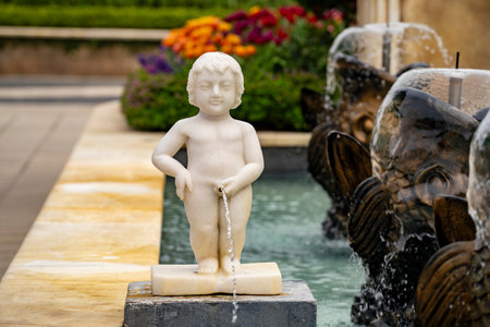 Statue of a boy in the form of a street fountain in a square in Da Nang, Vietnam, close upの写真素材