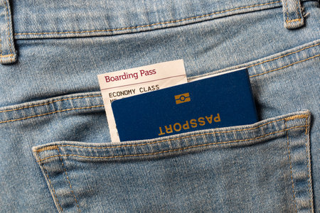 Blue passport and boarding pass in your pocket jeans, close up. Travel conceptの写真素材