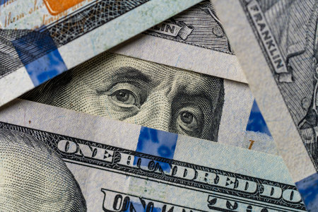 President's eyes in a triangle of hundred dollar bills, close up, top viewの写真素材