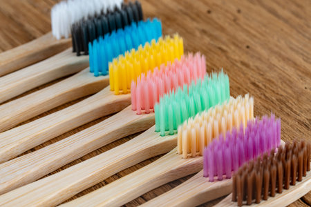 Set of multicolored bamboo toothbrushes on wooden background, close up. Zero waste, plastic free, eco friendly organic product conceptの写真素材