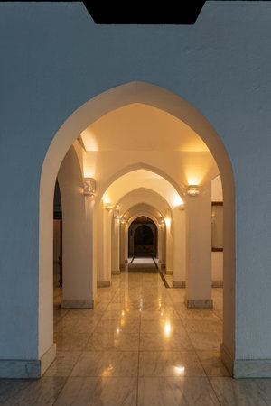 Detail of wall and corridor with many arches at night in Egypt hotel in Sharm el Sheikh, architecture conceptの写真素材