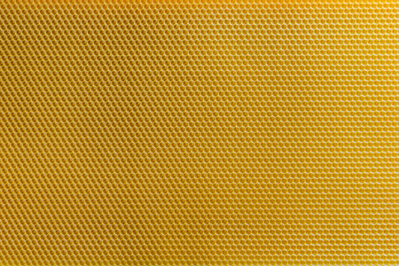 Background texture and pattern of section voshchina of wax honeycomb from a bee hive for filled with honey. Voshchina an artificial basis for the construction of honeycombs, sheet of wax of the cellsの写真素材