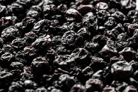 Dried wild blueberries background, close up, macro. Pile of dry blueberry from dehydrator. Concept of preserving vitamins for winter, healthy eatingの写真素材