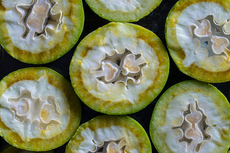 Green young walnuts cut in half, texture or background, macro, top view, close upの写真素材
