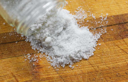 Salt crystals on a wooden boardの写真素材