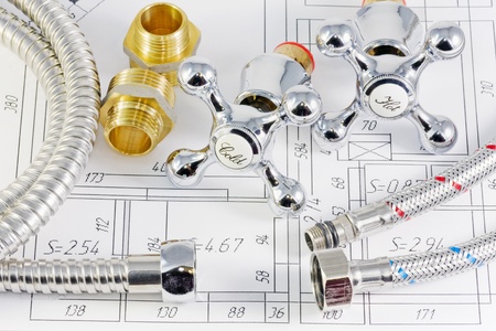 plumbing valves and hoses on the plan of the premisesの写真素材