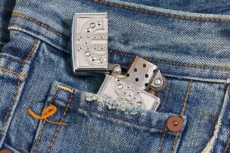petrol lighter in the pocket of blue jeansの写真素材