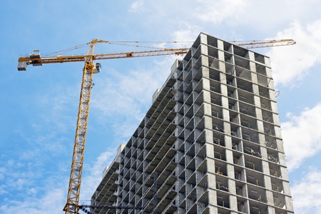 construction of a skyscraper on a background of blue skyの写真素材