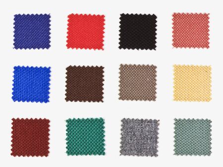 pieces of colored fabric glue onto a piece of cardboard の写真素材