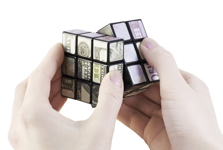 rotate the cube of the money in the hands ofの写真素材