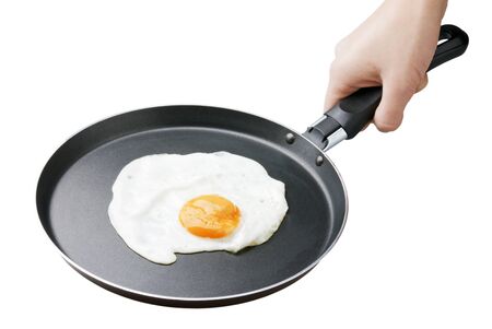 female hand holding a pan full of scramble eggs on white backgroundの写真素材