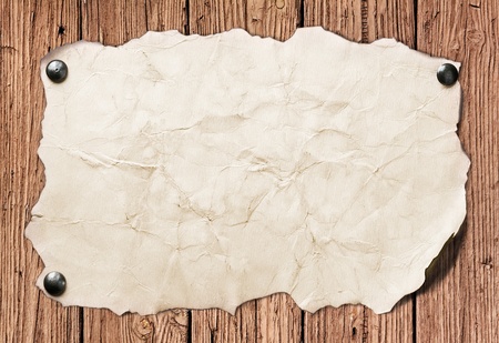 Old paper nailed to a wooden wallの写真素材