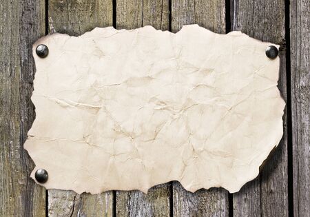 Old paper nailed to a wooden wallの写真素材