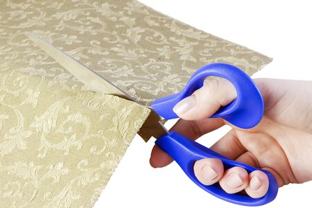 scissors in his hands cut tissue is isolated on a white backgroundの写真素材