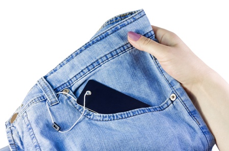 hand holds a pair of jeans with the label