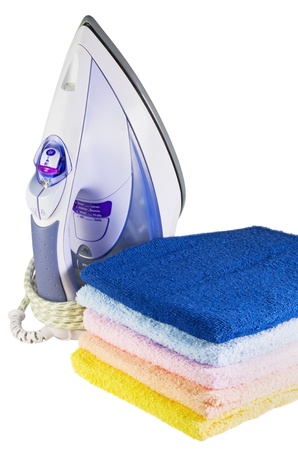 iron and colored towel isolated on white backgroundの写真素材
