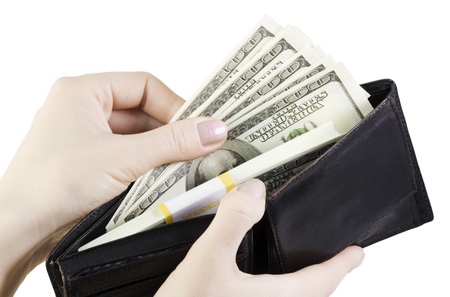 hand pulling dollars out of the walletの写真素材