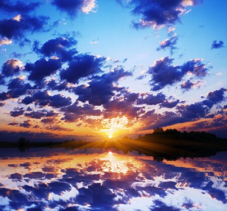 fiery dawn sun over the lakeの写真素材