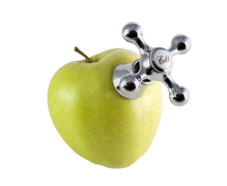 cold tap water on a green appleの写真素材