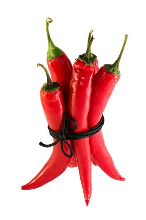 related acute red peppers isolated on a white cordの写真素材