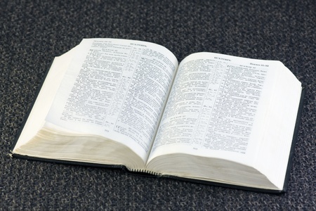 open Bible rests on a brown fabricの写真素材