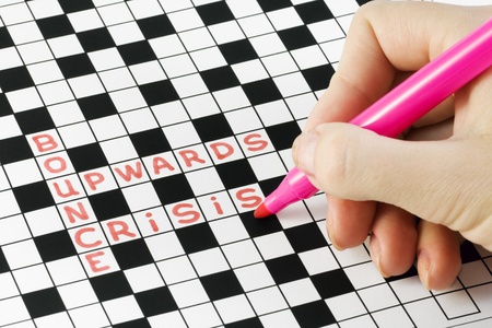hand with pen crossword puzzles about the crisis 
 の写真素材