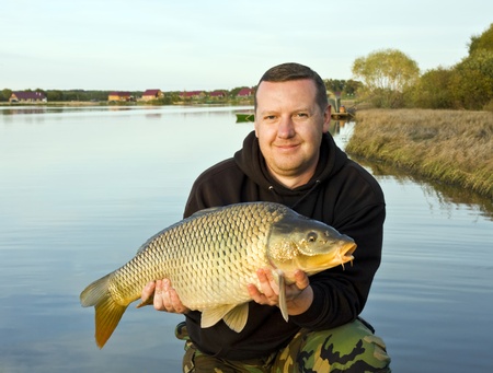 angler with carp to 15 pounds at sunset 
 の写真素材