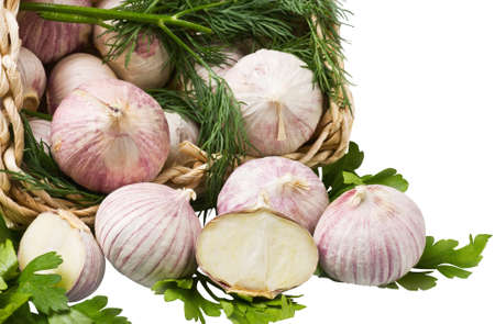 garlic in a basket isolated on white backgroundの写真素材