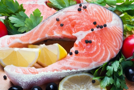 raw salmon steak with vegetables and spicesの写真素材